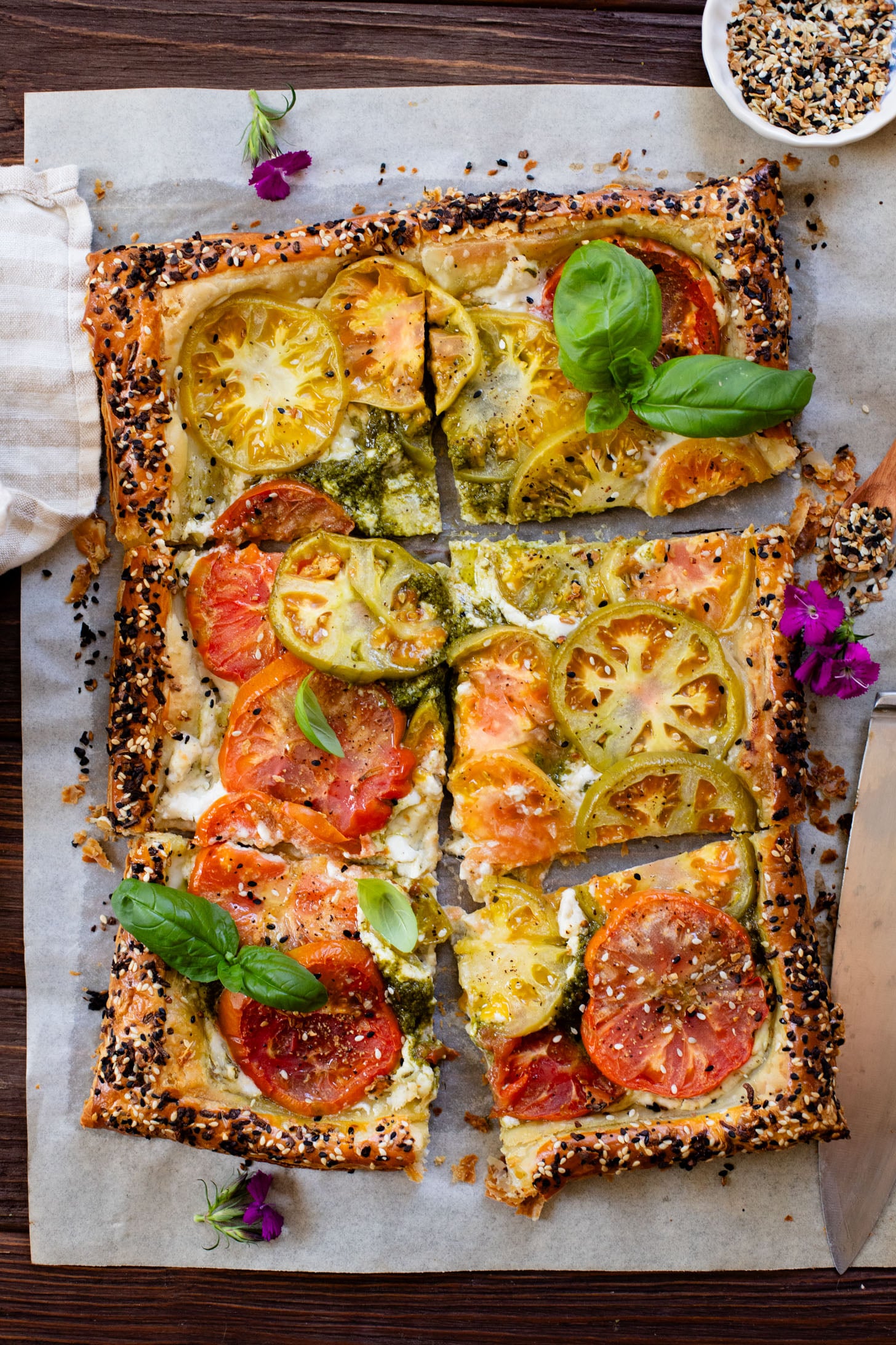 This vegan Heirloom Tomato Tart is made with puff pastry, a creamy non-dairy cheese, pesto & heirloom tomato slices. The perfect summer appetizer or brunch idea | ThisSavoryVegan.com #puffpastryideas #heirloomtomatorecipes #summerrecipes