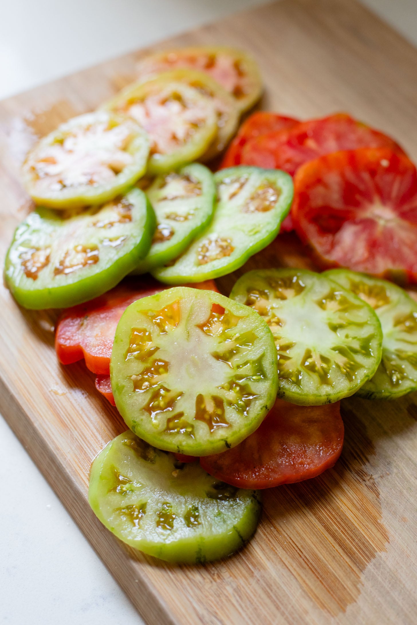 This vegan Heirloom Tomato Tart is made with puff pastry, a creamy non-dairy cheese, pesto & heirloom tomato slices. The perfect summer appetizer or brunch idea | ThisSavoryVegan.com #puffpastryideas #heirloomtomatorecipes #summerrecipes