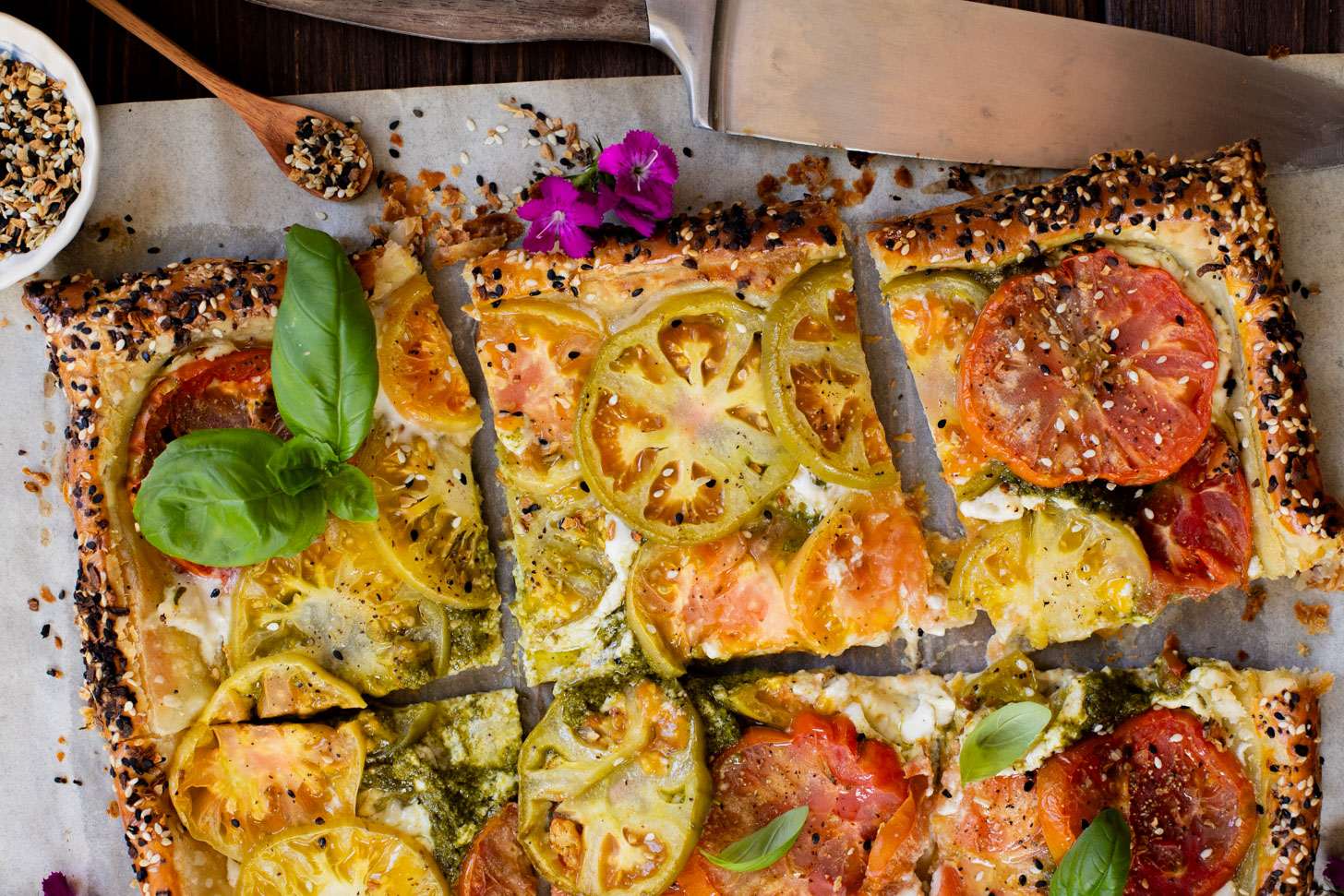 This vegan Heirloom Tomato Tart is made with puff pastry, a creamy non-dairy cheese, pesto & heirloom tomato slices. The perfect summer appetizer or brunch idea | ThisSavoryVegan.com #puffpastryideas #heirloomtomatorecipes #summerrecipes