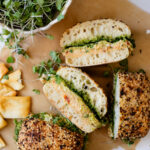 These Mediterranean Chickpea Salad Sandwiches are layered with vegan pesto, smashed chickpea salad, vegan feta and greens. The perfect vegan lunch | ThisSavoryVegan.com #vegansandwich #chickpearecipes #summerrecipes