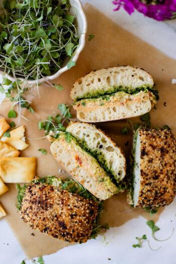 These Mediterranean Chickpea Salad Sandwiches are layered with vegan pesto, smashed chickpea salad, vegan feta and greens. The perfect vegan lunch | ThisSavoryVegan.com #vegansandwich #chickpearecipes #summerrecipes