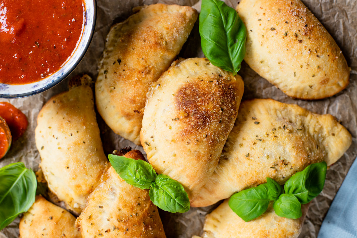 These Mediterranean Pizza Pockets are filled with vegan feta, vegan parmesan, sun-dried tomatoes, herbs & garlic. The perfect vegan snack or kid-friendly dinner | ThisSavoryVegan.com #thissavoryvegan #homemadepizzapockets #veganpizza