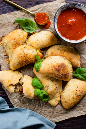 These Mediterranean Pizza Pockets are filled with vegan feta, vegan parmesan, sun-dried tomatoes, herbs & garlic. The perfect vegan snack or kid-friendly dinner | ThisSavoryVegan.com #thissavoryvegan #homemadepizzapockets #veganpizza