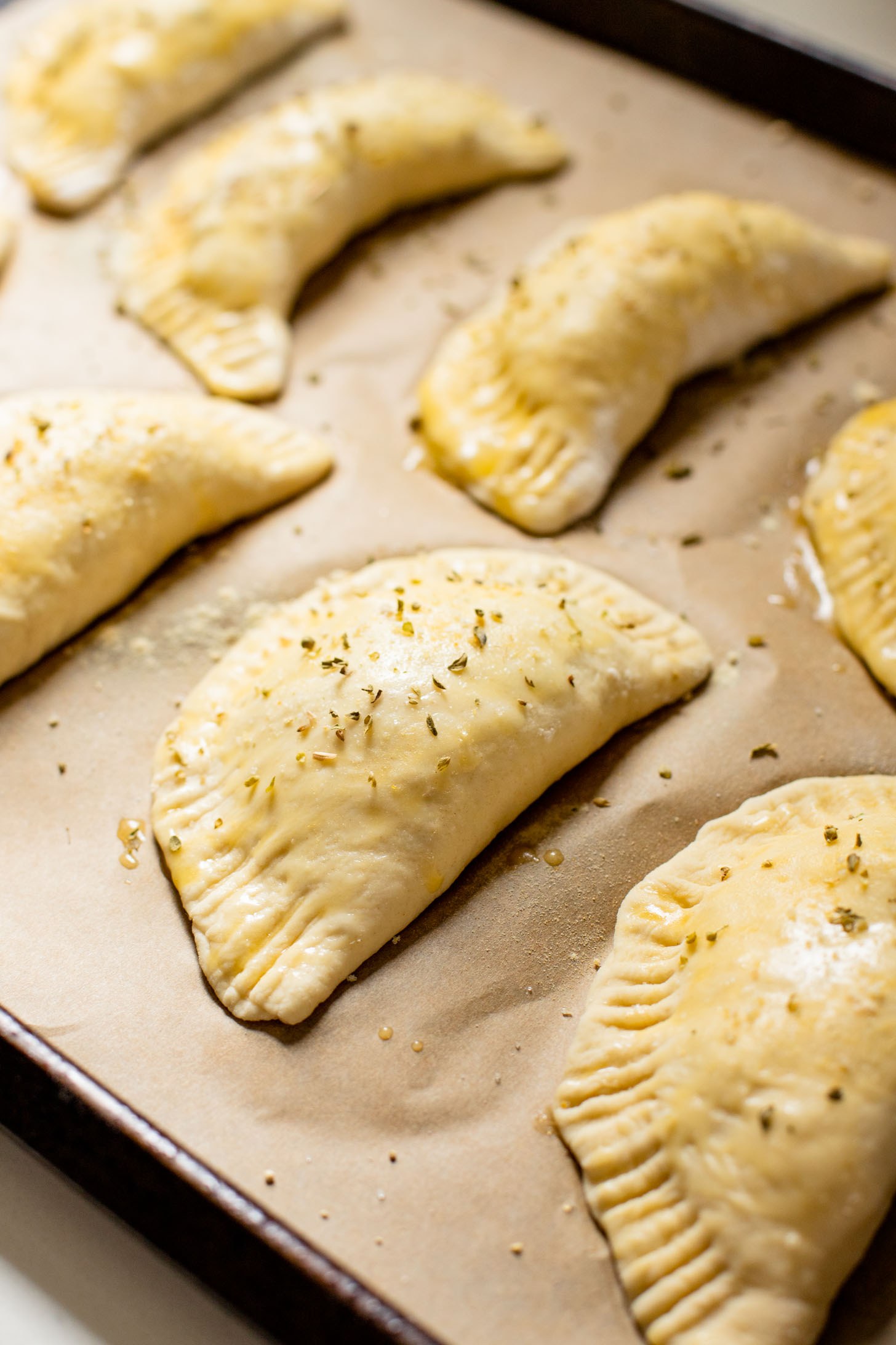 These Mediterranean Pizza Pockets are filled with vegan feta, vegan parmesan, sun-dried tomatoes, herbs & garlic. The perfect vegan snack or kid-friendly dinner | ThisSavoryVegan.com #thissavoryvegan #homemadepizzapockets #veganpizza