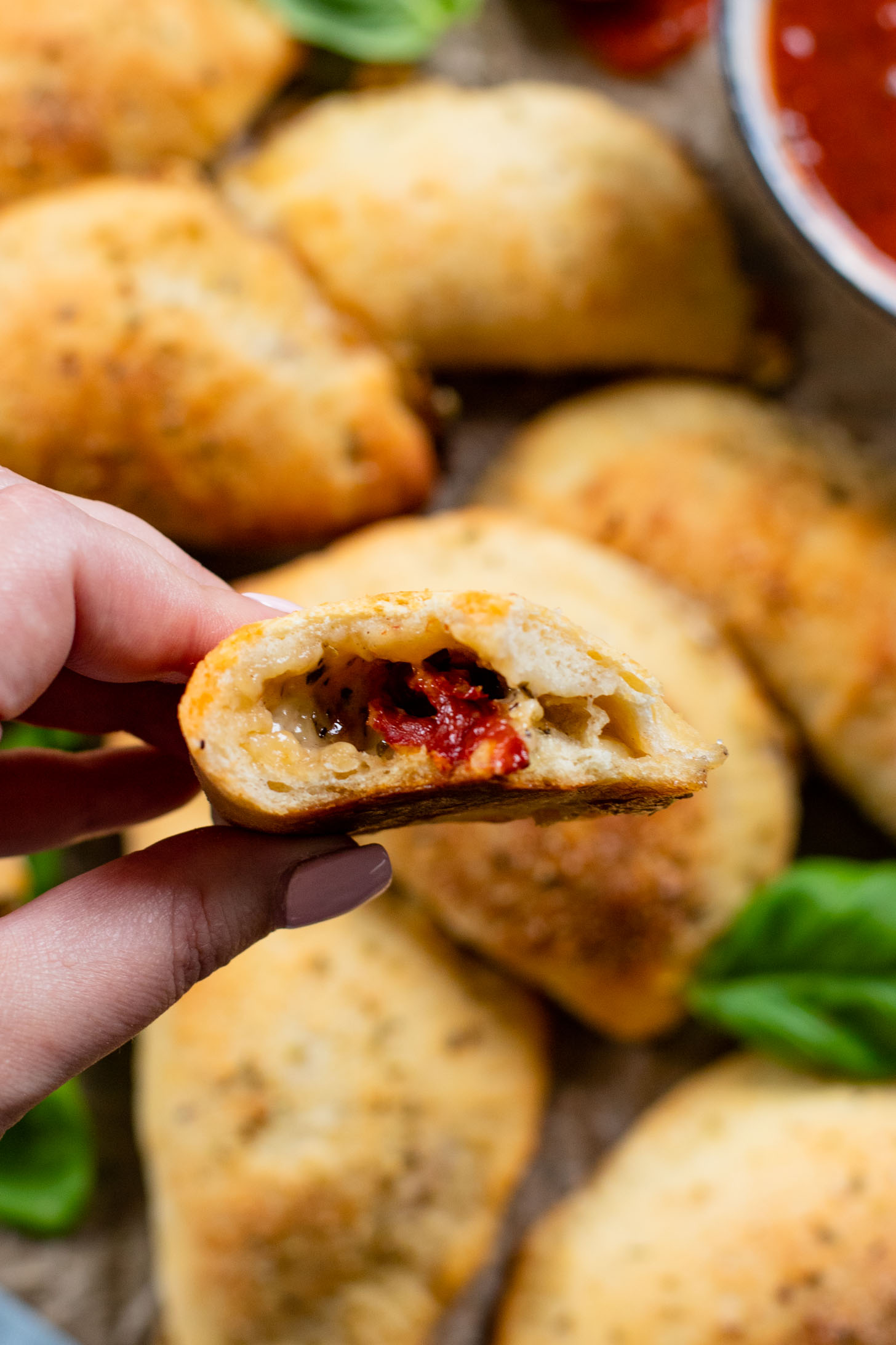 These Mediterranean Pizza Pockets are filled with vegan feta, vegan parmesan, sun-dried tomatoes, herbs & garlic. The perfect vegan snack or kid-friendly dinner | ThisSavoryVegan.com #thissavoryvegan #homemadepizzapockets #veganpizza