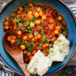These simple Tomato Braised Chickpeas are made in one pot with just a few ingredients. Serve with crusty bread for an easy vegan dinner | ThisSavoryVegan.com #chickpearecipes #easydinner #veggiedinner