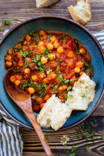 These simple Tomato Braised Chickpeas are made in one pot with just a few ingredients. Serve with crusty bread for an easy vegan dinner | ThisSavoryVegan.com #chickpearecipes #easydinner #veggiedinner