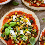 These Zucchini & Corn Pesto Pitas have sautéed summer veggies, chickpeas, roasted red pepper pesto, warm pita bread & fresh herbs. A great lunch or dinner idea | ThisSavoryVegan.com #summerveggies #veganlunchideas #easydinnerrecipes