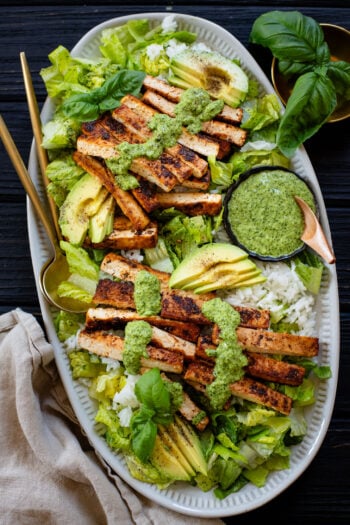 This Crispy Tofu & Rice Salad is made with marinated & baked tofu strips, rice, romaine, avocado and a delicious & tangy green dressing | ThisSavoryVegan.com #tofusalad #vegansalads #summersaladidea