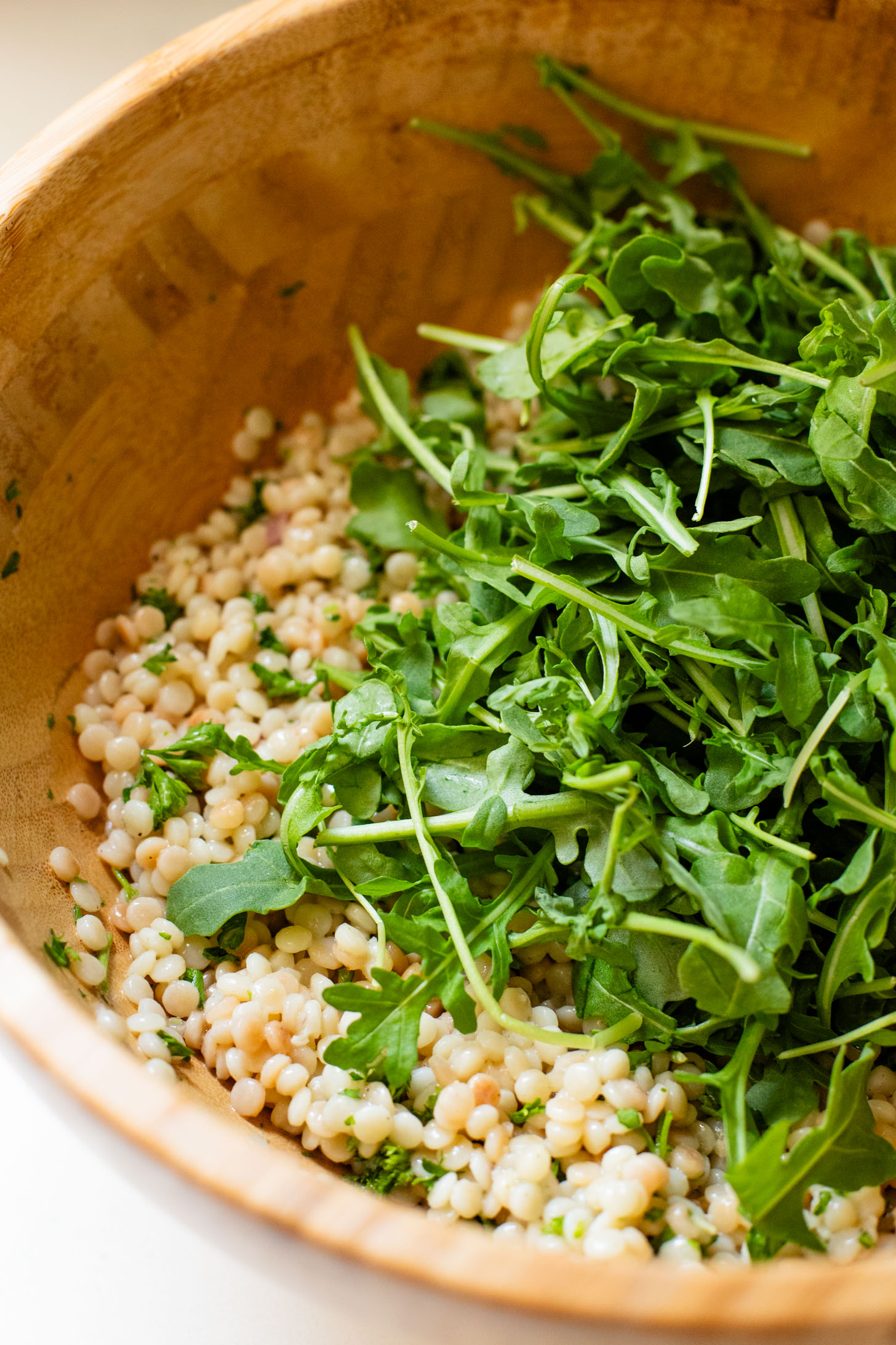 This Lemon Arugula Couscous Salad is a simple vegan salad that packs a ton of flavor! Made with pearl couscous and vegan feta. The perfect bite | ThisSavoryVegan.com #thissavoryvegan #summersalad #veganlunchideas