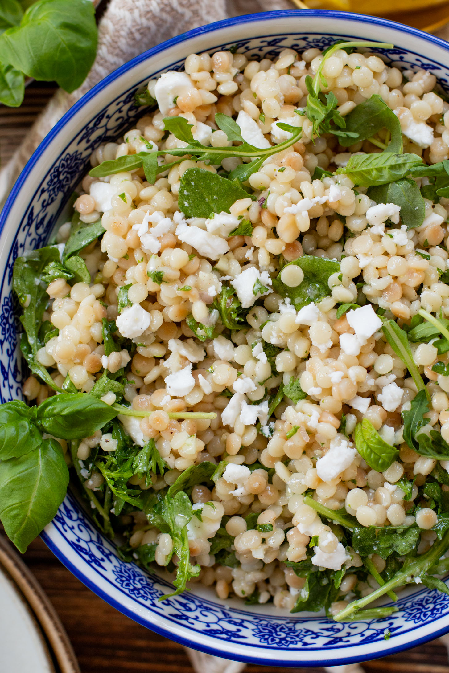 This Lemon Arugula Couscous Salad is a simple vegan salad that packs a ton of flavor! Made with pearl couscous and vegan feta. The perfect bite | ThisSavoryVegan.com #thissavoryvegan #summersalad #veganlunchideas