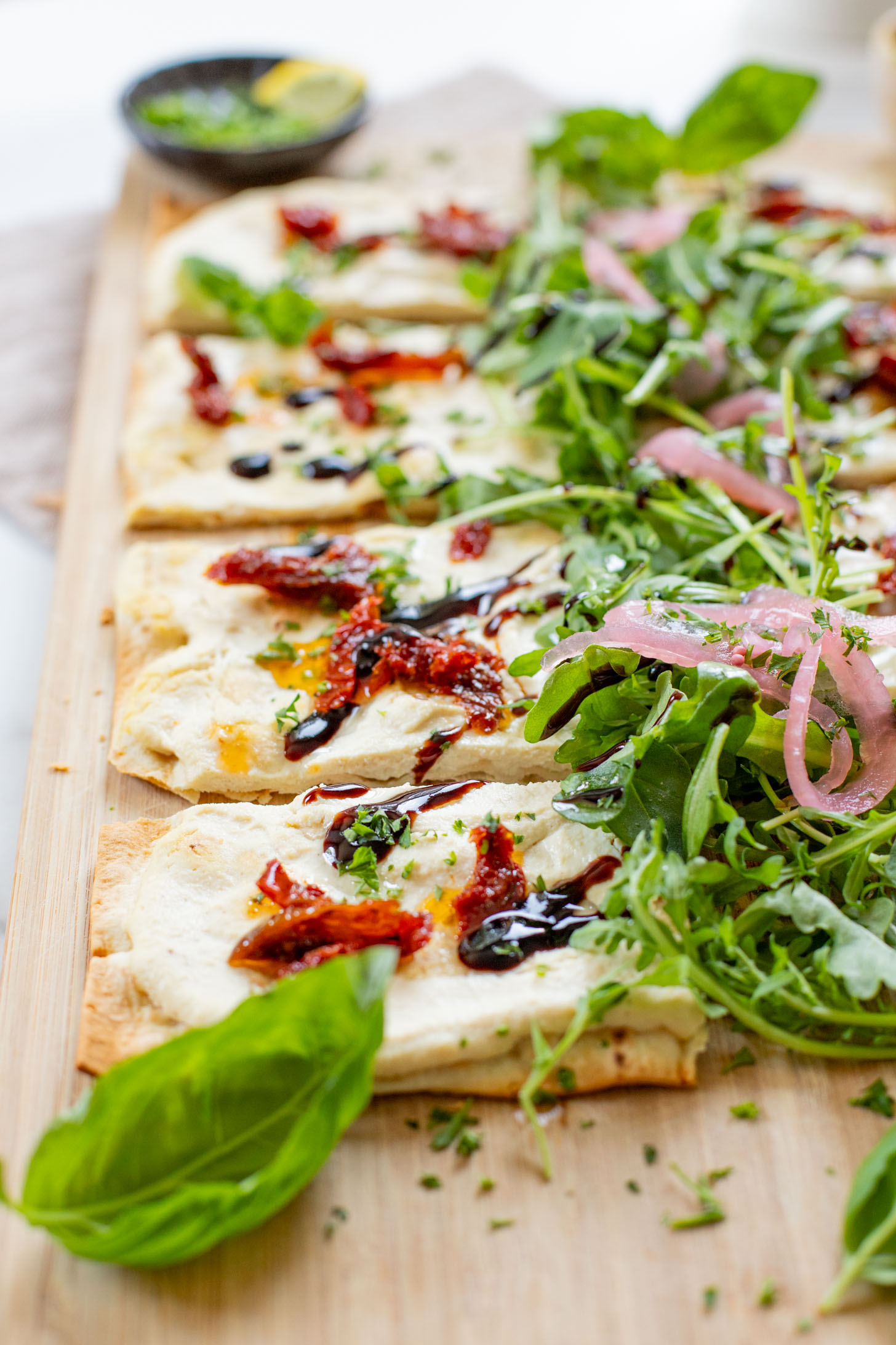 This Lemon Ricotta Lavash Pizza is the perfect vegan appetizer, lunch or light dinner! A super thin lavash crust, tofu ricotta and lots of toppings | ThisSavoryVegan.com #thissavoryvegan #veganpizza #veganappetizers