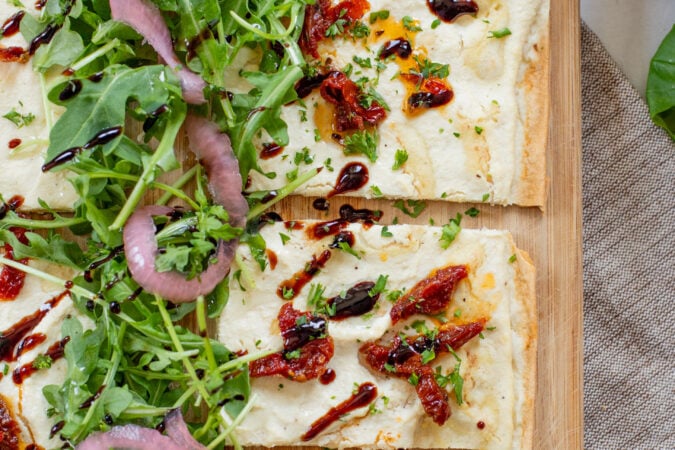 This Lemon Ricotta Lavash Pizza is the perfect vegan appetizer, lunch or light dinner! A super thin lavash crust, tofu ricotta and lots of toppings | ThisSavoryVegan.com #thissavoryvegan #veganpizza #veganappetizers