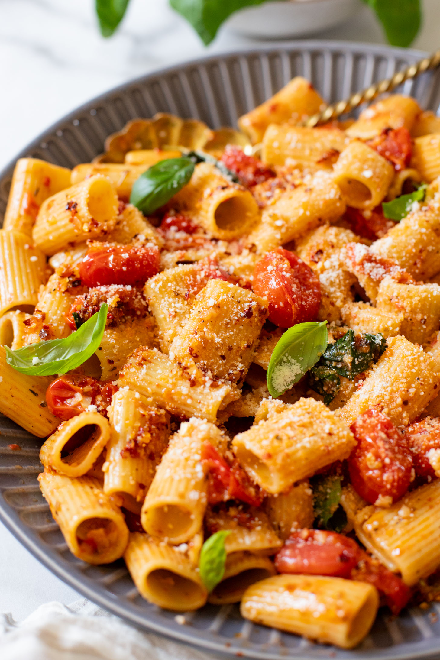 This Spicy Burst Tomato Pasta is a simple vegan pasta recipe made with cherry tomatoes, lots of garlic & basil and chili crisp oil for some heat | ThisSavoryVegan.com #thissavoryvegan #veganpasta #spicypasta