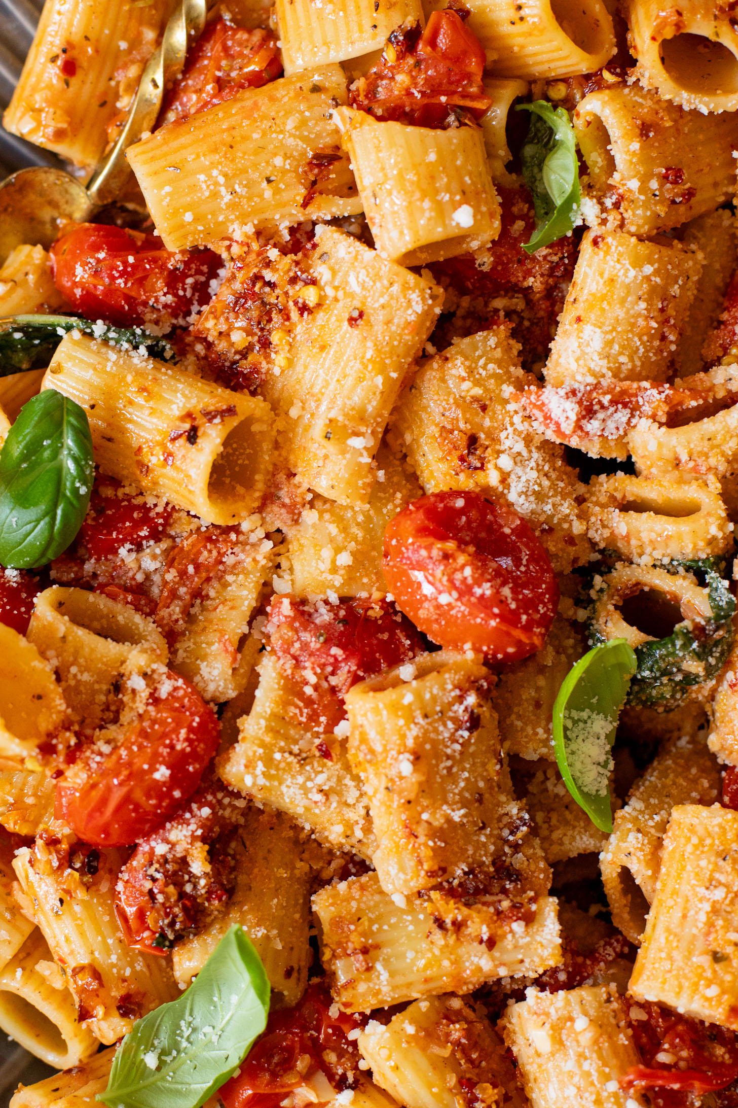 This Spicy Burst Tomato Pasta is a simple vegan pasta recipe made with cherry tomatoes, lots of garlic & basil and chili crisp oil for some heat | ThisSavoryVegan.com #thissavoryvegan #veganpasta #spicypasta