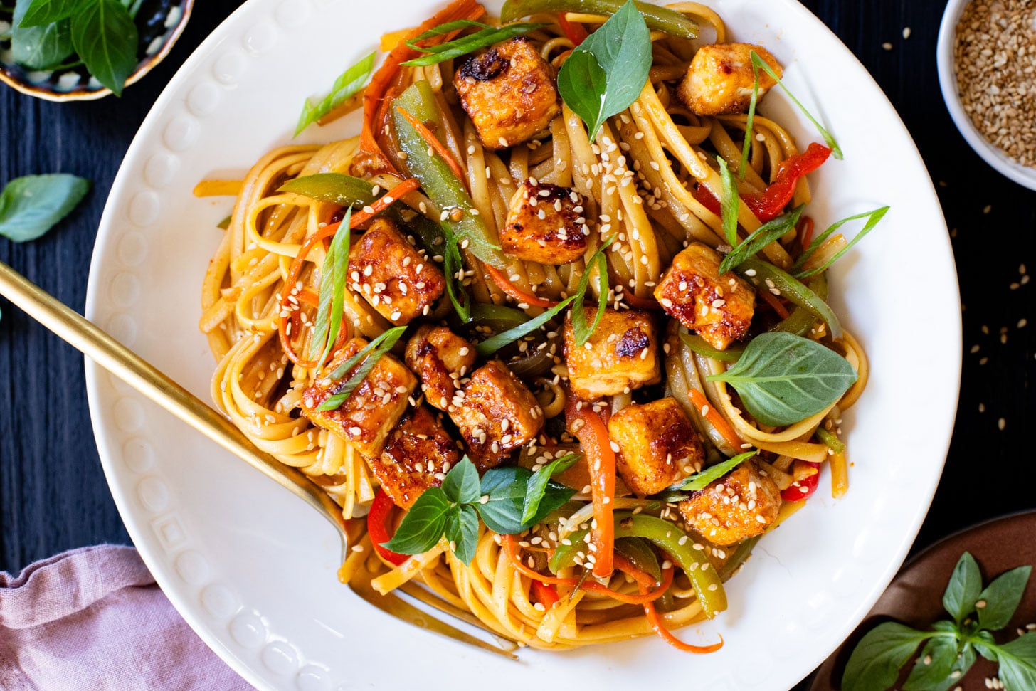 This Tofu Noodle Stir-Fry is loaded with crispy tofu, tons of veggies and noodles tossed in a homemade vegan stir-fry sauce | ThisSavoryVegan.com #thissavoryvegan #vegannoodles #veganstirfry