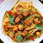 This Tofu Noodle Stir-Fry is loaded with crispy tofu, tons of veggies and noodles tossed in a homemade vegan stir-fry sauce | ThisSavoryVegan.com #thissavoryvegan #vegannoodles #veganstirfry