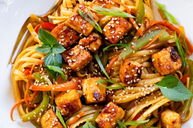 This Tofu Noodle Stir-Fry is loaded with crispy tofu, tons of veggies and noodles tossed in a homemade vegan stir-fry sauce | ThisSavoryVegan.com #thissavoryvegan #vegannoodles #veganstirfry