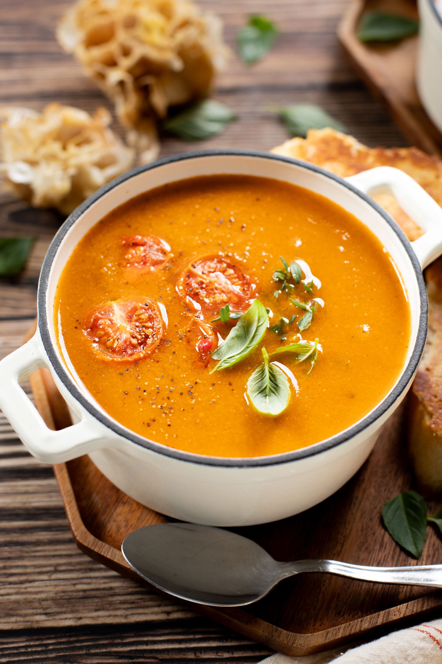 This Roasted Garlic Tomato Soup is creamy, savory & delicious. Served with vegan parmesan toast and topped with fresh basil | ThisSavoryVegan.com #tomatosoup #soupseason #vegansoup