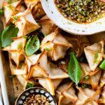 These Baked Butternut Squash Wontons are filled with roasted squash and served with a homemade dipping sauce. The most comforting vegan appetizer | ThisSavoryVegan.com #thissavoryvegan #veganwontons #vegandumplings