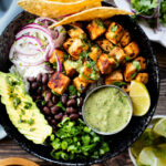 These Chipotle Tofu Burrito Bowls are filled with crispy baked tofu, black beans, rice, veggies and a super delicious cilantro yogurt sauce | ThisSavoryVegan.com #thissavoryvegan #burritobowls #tofurecipes