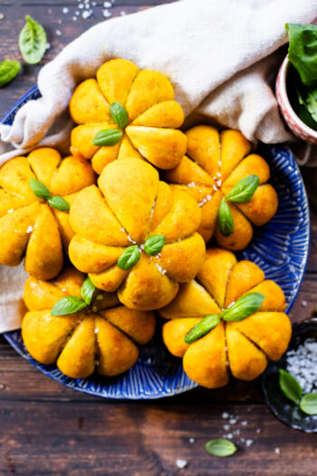 These Pumpkin Shaped Pizza Bites are stuffed with a mediterranean, dairy-free filling that is delicious! The perfect vegan fall recipe | ThisSavoryVegan.com #halloweenrecipes #thanksgivingrecipes #thanksgivingappetizers