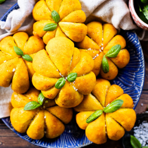 These Pumpkin Shaped Pizza Bites are stuffed with a mediterranean, dairy-free filling that is delicious! The perfect vegan fall recipe | ThisSavoryVegan.com #halloweenrecipes #thanksgivingrecipes #thanksgivingappetizers