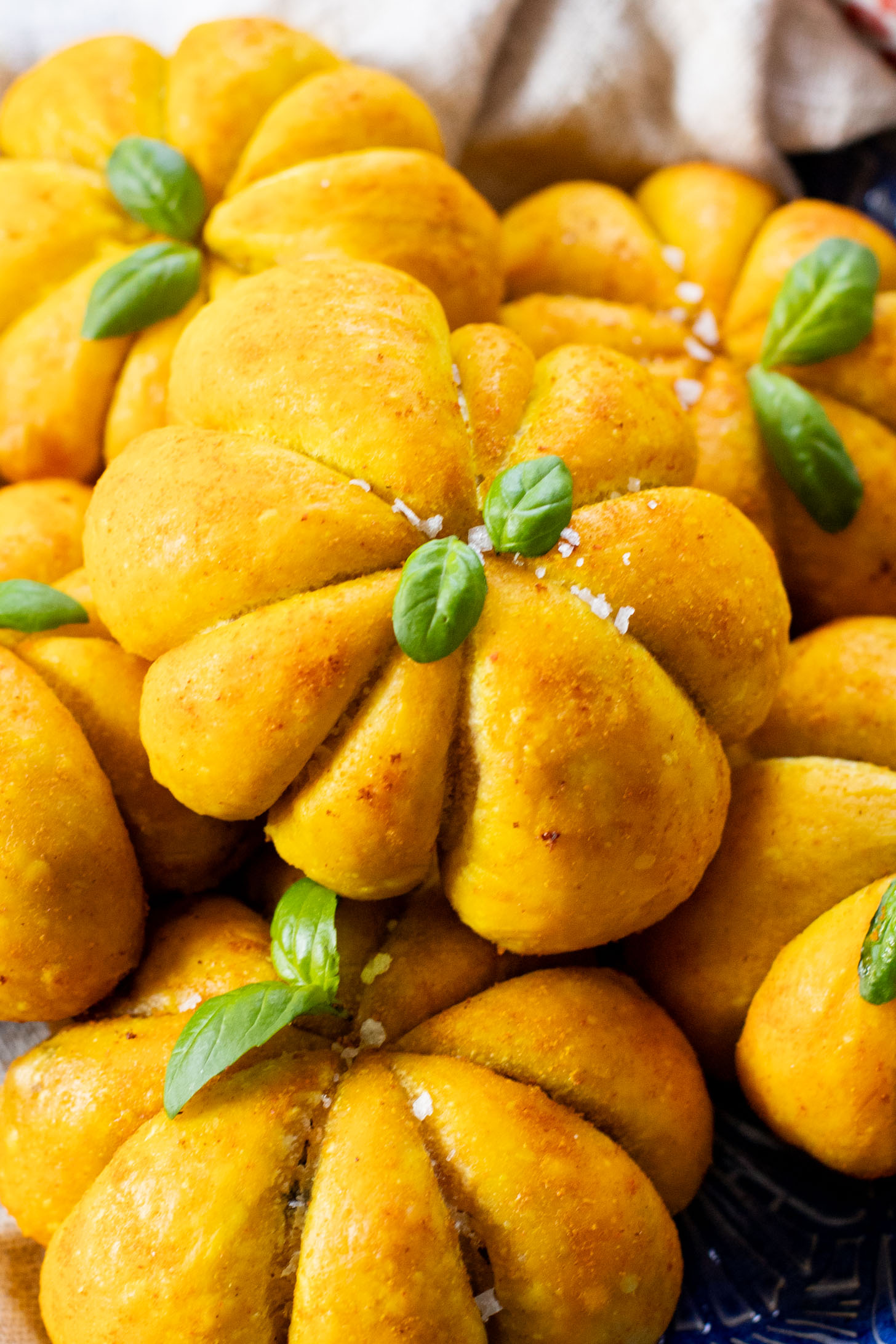 These Pumpkin Shaped Pizza Bites are stuffed with a mediterranean, dairy-free filling that is delicious! The perfect vegan fall recipe | ThisSavoryVegan.com #halloweenrecipes #thanksgivingrecipes #thanksgivingappetizers