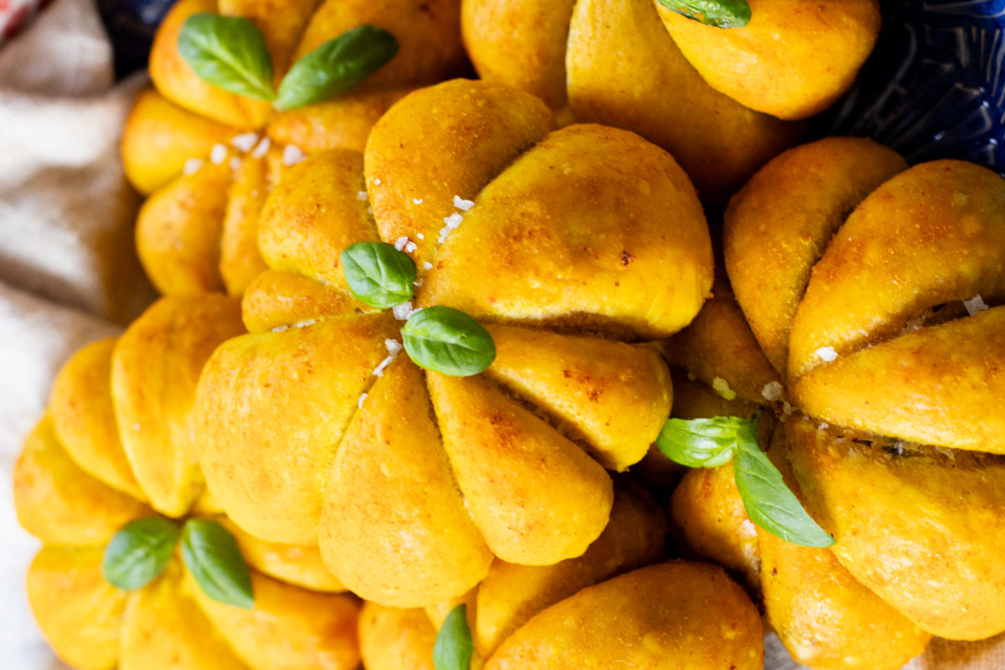 These Pumpkin Shaped Pizza Bites are stuffed with a mediterranean, dairy-free filling that is delicious! The perfect vegan fall recipe | ThisSavoryVegan.com #halloweenrecipes #thanksgivingrecipes #thanksgivingappetizers