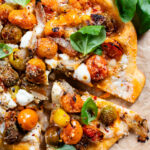 This Vegan Feta & Tomato Pizza is the ultimate dairy-free pizza! Layered with roasted tomatoes, shallots, garlic and crumbled vegan feta | ThisSavoryVegan.com #thissavoryvegan #veganpizza #dairyfreepizza