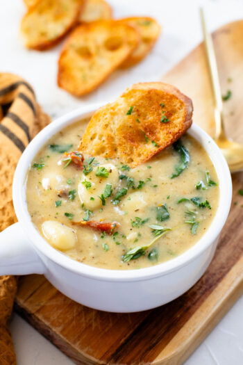 This Vegan Spinach & Gnocchi Soup is creamy and comforting. A dairy-free creamy soup that is easy to make and perfect on a cold night | ThisSavoryVegan.com #vegansoup #creamysoup #dairyfreesoup