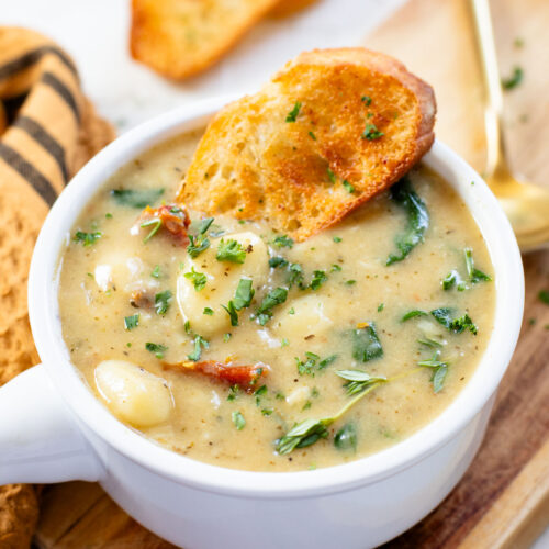 This Vegan Spinach & Gnocchi Soup is creamy and comforting. A dairy-free creamy soup that is easy to make and perfect on a cold night | ThisSavoryVegan.com #vegansoup #creamysoup #dairyfreesoup