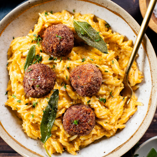 This Butternut Squash Orzo & Bean Meatballs recipe is a fall dinner dream! Orzo tossed in a butternut squash sauce, kidney bean "meatballs" and vegan brown butter & sage drizzle | ThisSavoryVegan.com #thissavoryvegan #veganmeatballs #falldinnerrecipes