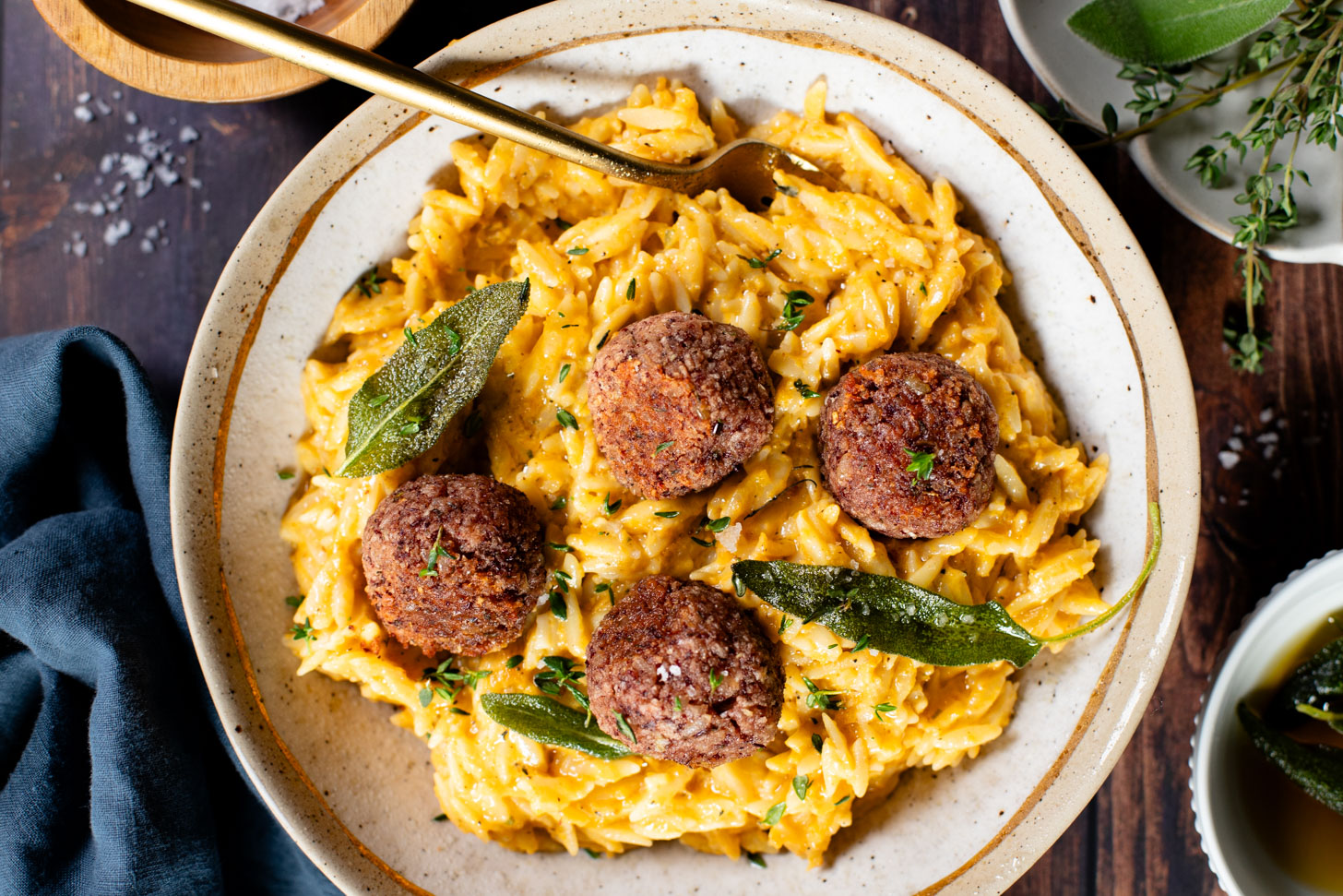 This Butternut Squash Orzo & Bean Meatballs recipe is a fall dinner dream! Orzo tossed in a butternut squash sauce, kidney bean "meatballs" and vegan brown butter & sage drizzle | ThisSavoryVegan.com #thissavoryvegan #veganmeatballs #falldinnerrecipes