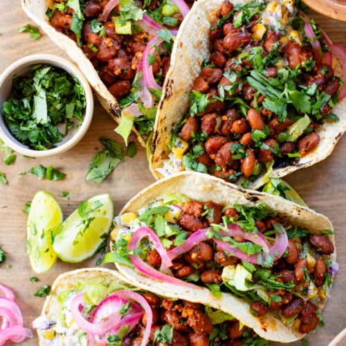 These Corn Salad & Bean Tacos are simple, vegan & delicious. Ready in 30 minutes and served with a Mexican corn salad, beans & pickled onions | ThisSavoryVegan.com #thissavoryvegan #vegantacos #beantacos