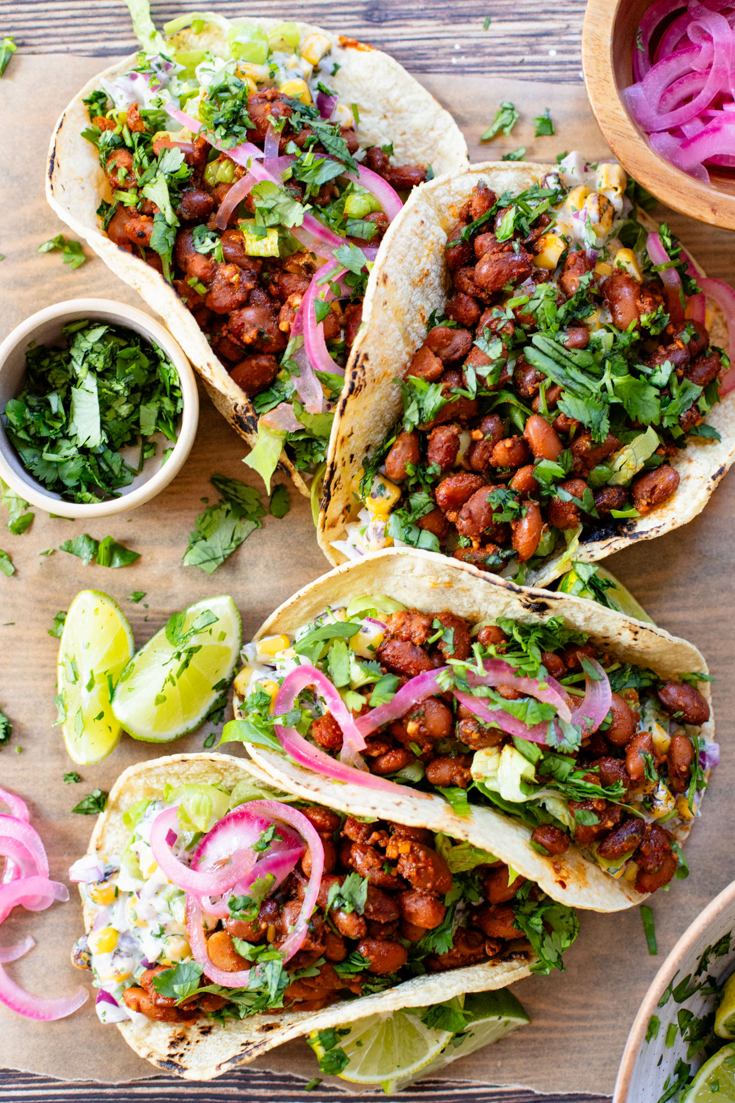 These Corn Salad & Bean Tacos are simple, vegan & delicious. Ready in 30 minutes and served with a Mexican corn salad, beans & pickled onions | ThisSavoryVegan.com #thissavoryvegan #vegantacos #beantacos