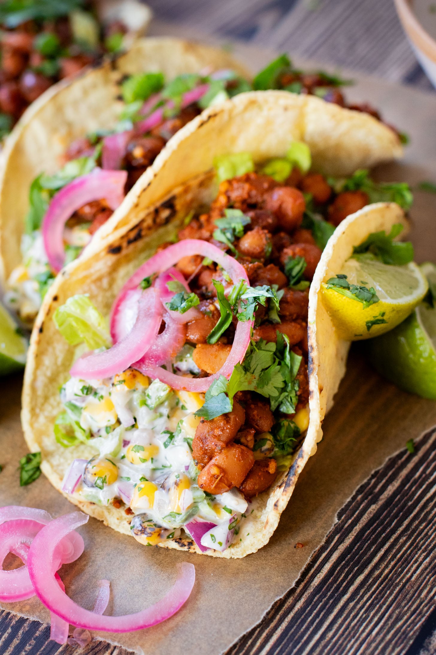 These Corn Salad & Bean Tacos are simple, vegan & delicious. Ready in 30 minutes and served with a Mexican corn salad, beans & pickled onions | ThisSavoryVegan.com #thissavoryvegan #vegantacos #beantacos