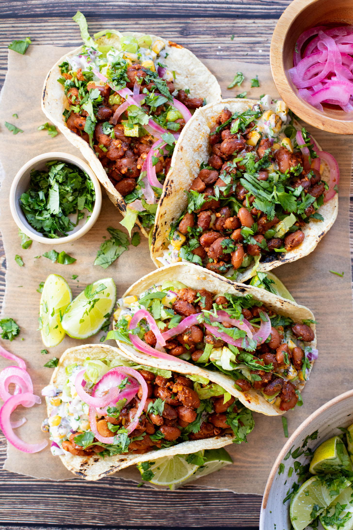 These Corn Salad & Bean Tacos are simple, vegan & delicious. Ready in 30 minutes and served with a Mexican corn salad, beans & pickled onions | ThisSavoryVegan.com #thissavoryvegan #vegantacos #beantacos