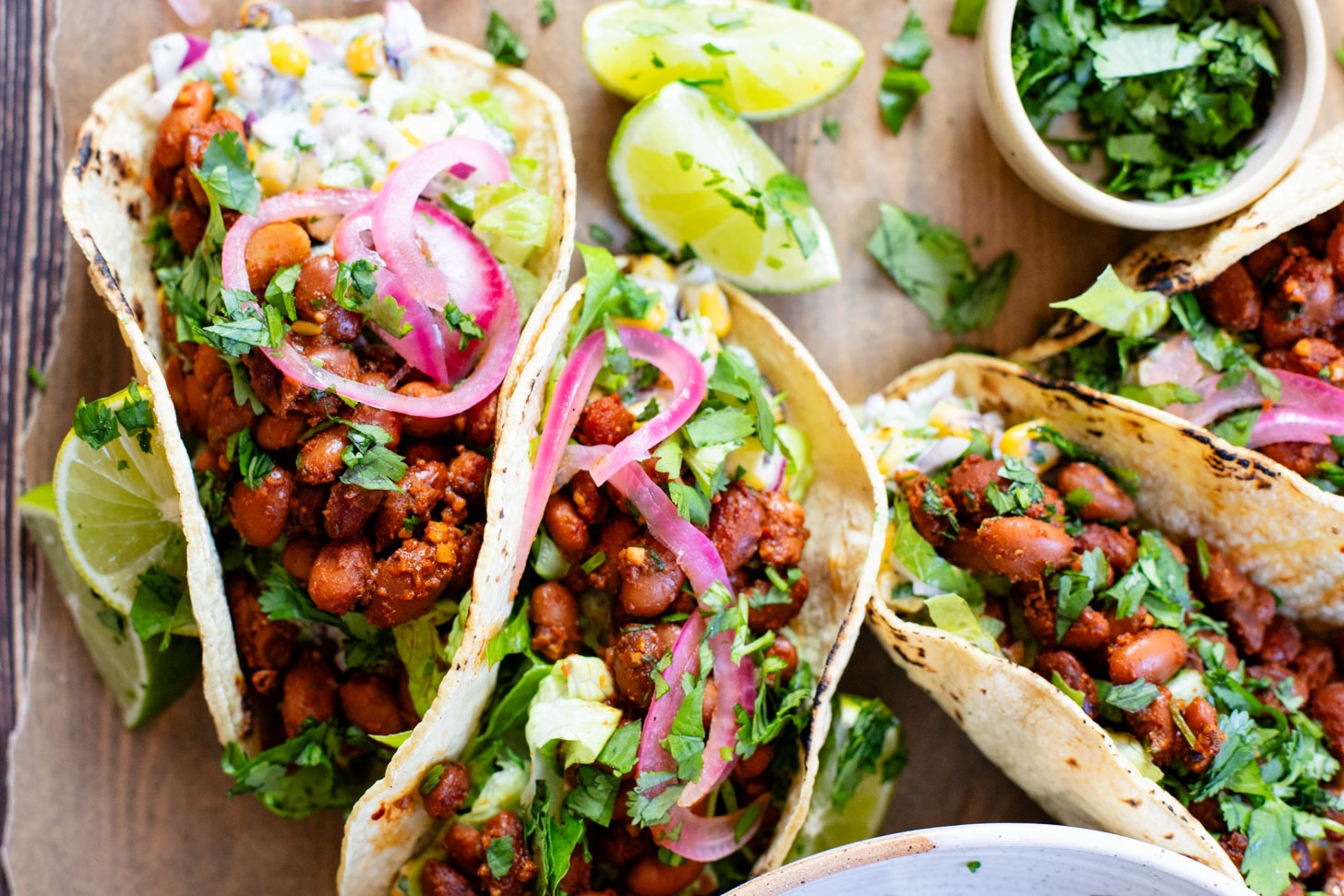 These Corn Salad & Bean Tacos are simple, vegan & delicious. Ready in 30 minutes and served with a Mexican corn salad, beans & pickled onions | ThisSavoryVegan.com #thissavoryvegan #vegantacos #beantacos