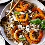 This Roasted Squash & Lentils recipe is a mix between a salad and a bowl. Crispy delicata squash, vegan feta and lemony lentils with fresh herbs | ThisSavoryVegan.com #thissavoryvegan #squashrecipes #fallrecipes
