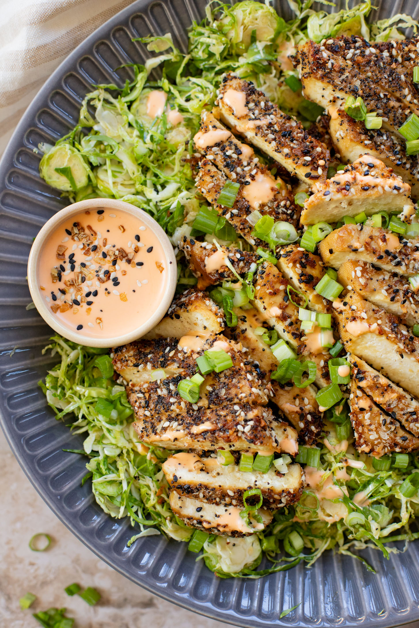 This Sesame Crusted Tofu Brussels Sprouts Salad is quick, light and protein packed. Raw shaved brussels sprouts and baked tofu in a maple dressing | ThisSavoryVegan.com #thissavoryvegan #bakedtofu #easytofurecipes