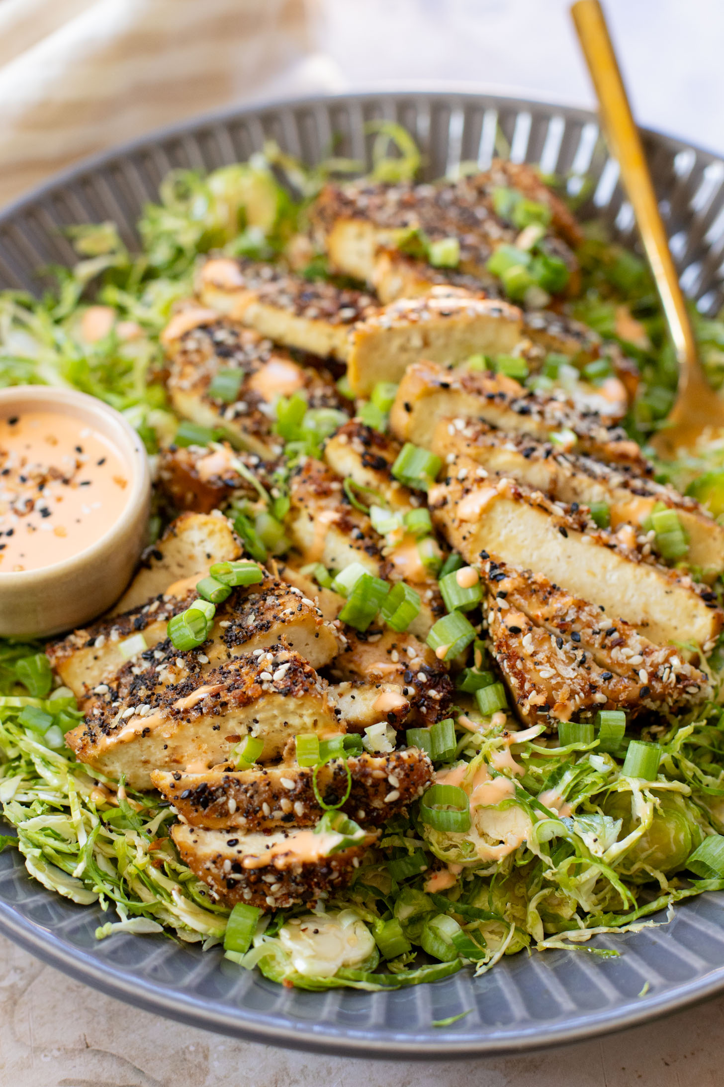 This Sesame Crusted Tofu Brussels Sprouts Salad is quick, light and protein packed. Raw shaved brussels sprouts and baked tofu in a maple dressing | ThisSavoryVegan.com #thissavoryvegan #bakedtofu #easytofurecipes