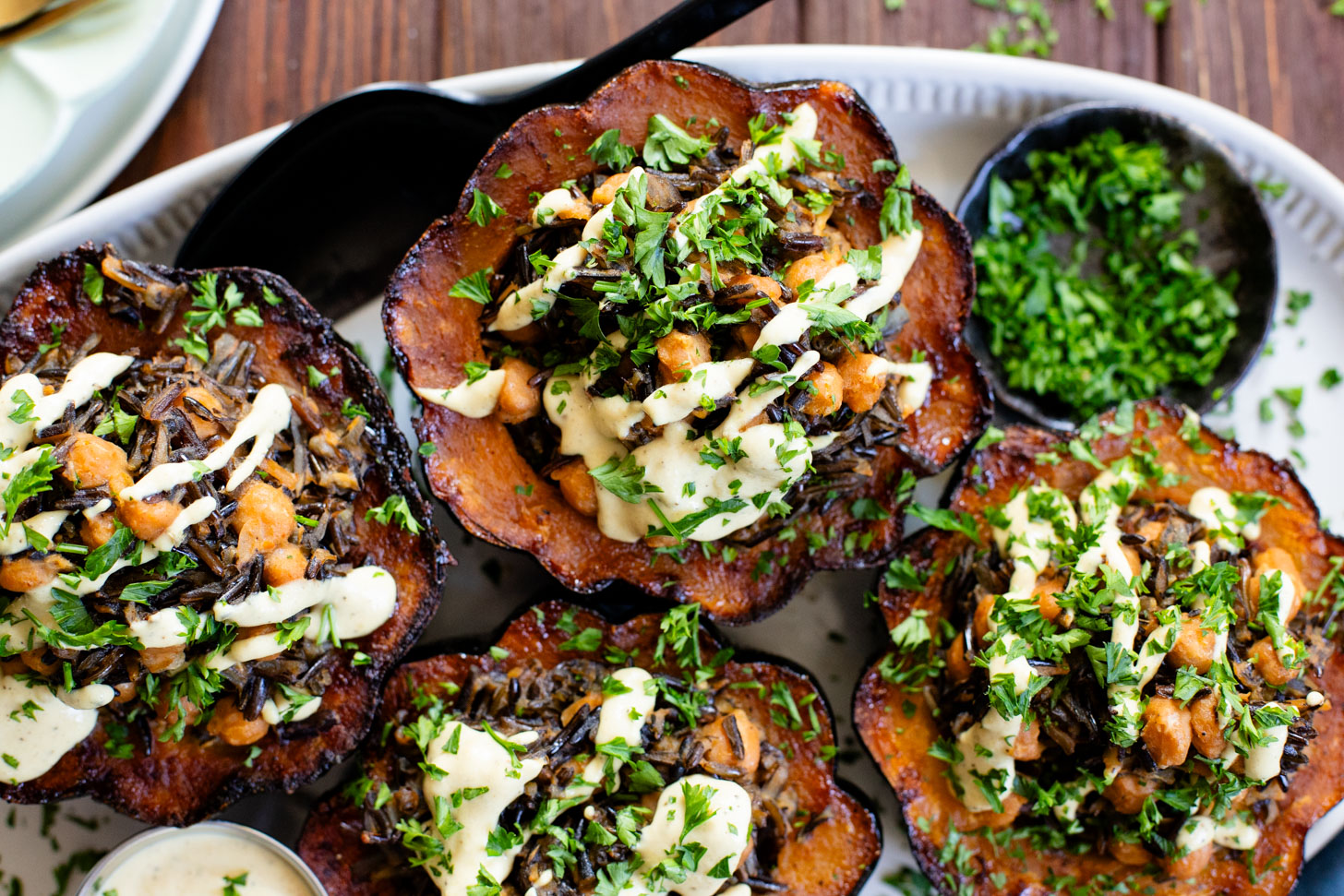 This Wild Rice Stuffed Acorn Squash recipe is filled with fall flavors. The squash is roasted until tender and stuffed with wild rice & chickpeas | ThisSavoryVegan.com #fallrecipes #wildricerecipes #falldinnerideas