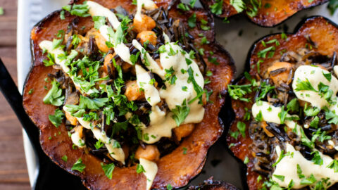 This Wild Rice Stuffed Acorn Squash recipe is filled with fall flavors. The squash is roasted until tender and stuffed with wild rice & chickpeas | ThisSavoryVegan.com #fallrecipes #wildricerecipes #falldinnerideas