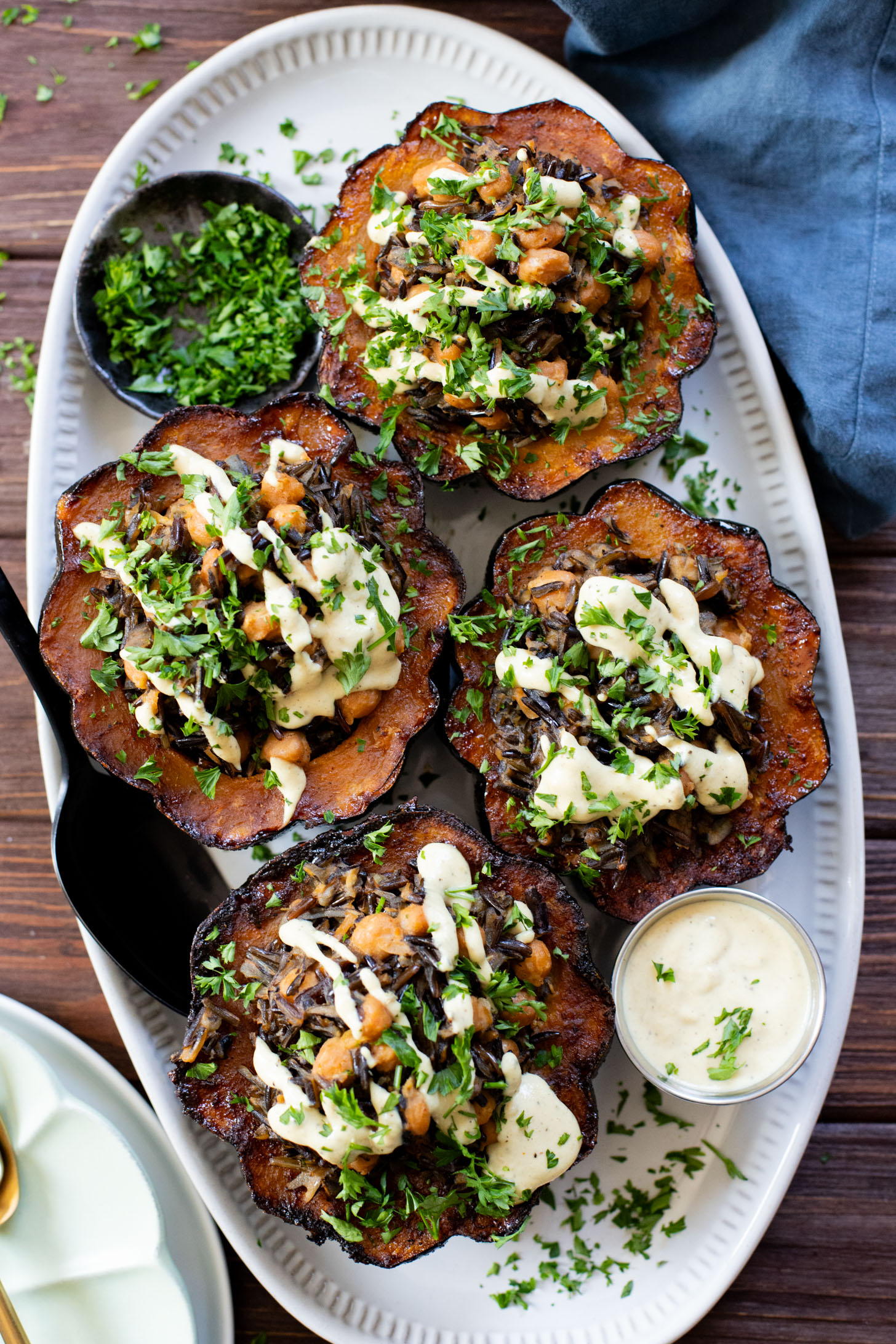 This Wild Rice Stuffed Acorn Squash recipe is filled with fall flavors. The squash is roasted until tender and stuffed with wild rice & chickpeas | ThisSavoryVegan.com #fallrecipes #wildricerecipes #falldinnerideas