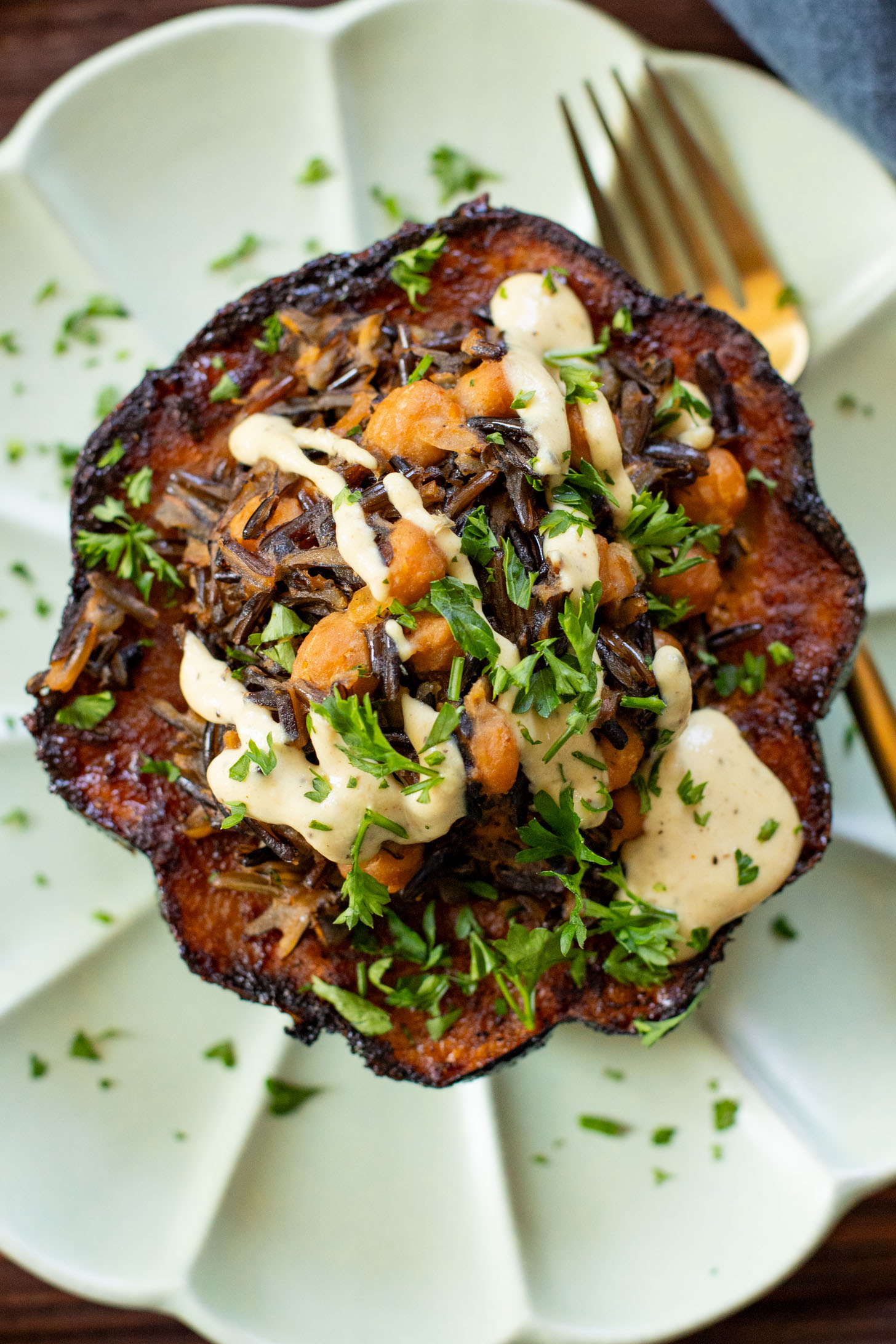 This Wild Rice Stuffed Acorn Squash recipe is filled with fall flavors. The squash is roasted until tender and stuffed with wild rice & chickpeas | ThisSavoryVegan.com #fallrecipes #wildricerecipes #falldinnerideas