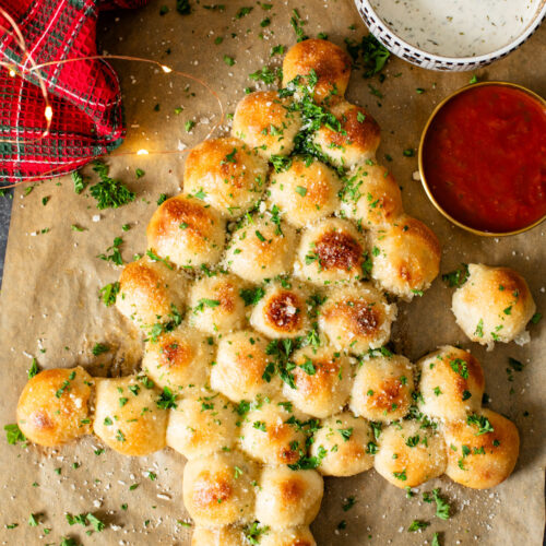 This Cheesy Pull-Apart Christmas Tree is pizza dough balls that are stuffed with a vegan jalapeño popper mixture. Perfect holiday appetizer | ThisSavoryVegan.com #thissavoryvegan #christmasappetizers #christmasrecipes