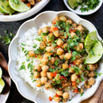 These Cilantro Lime Braised Chickpeas are simple, delicious and veggie-packed. Made in a dairy-free cream sauce and served over rice | ThisSavoryVegan.com #thissavoryvegan #easyvegandinners #quickdinnerideas