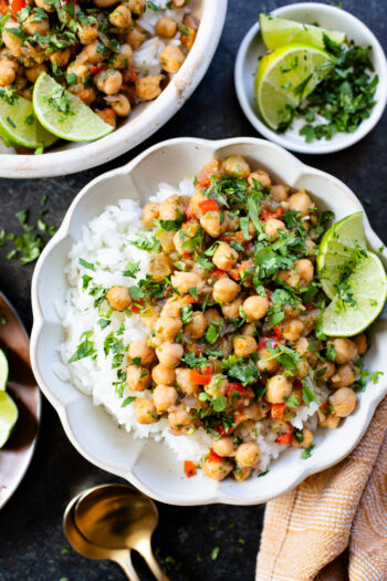 These Cilantro Lime Braised Chickpeas are simple, delicious and veggie-packed. Made in a dairy-free cream sauce and served over rice | ThisSavoryVegan.com #thissavoryvegan #easyvegandinners #quickdinnerideas