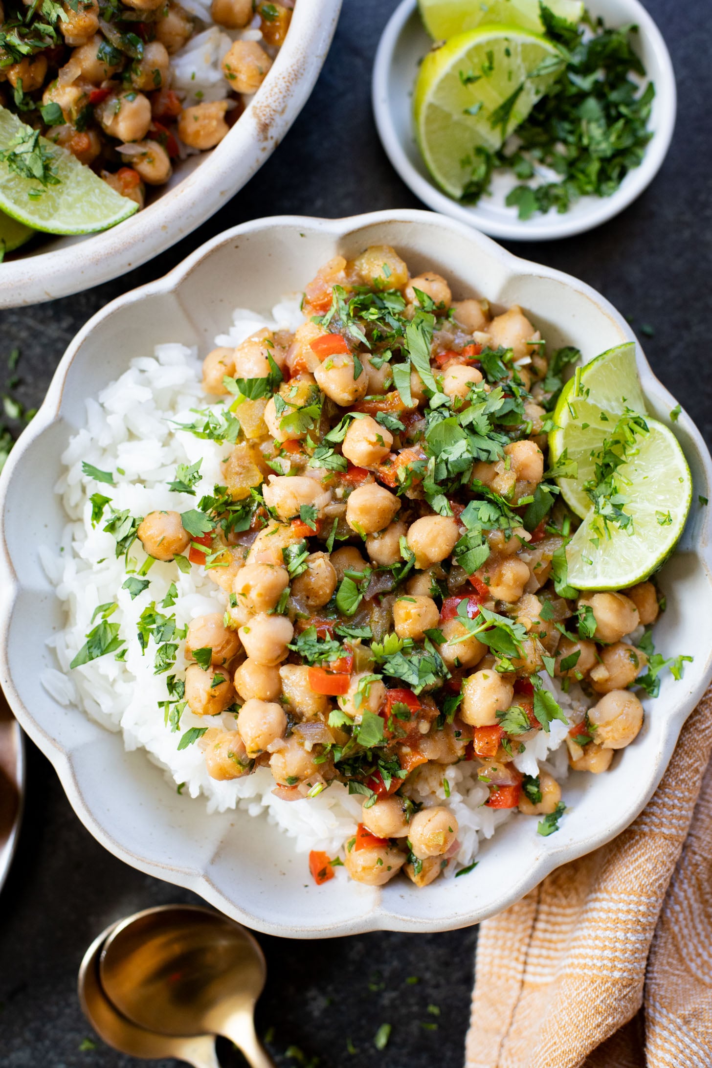 These Cilantro Lime Braised Chickpeas are simple, delicious and veggie-packed. Made in a dairy-free cream sauce and served over rice | ThisSavoryVegan.com #thissavoryvegan #easyvegandinners #quickdinnerideas